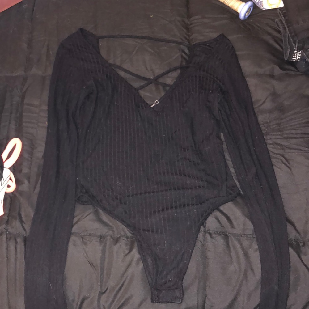 Black V-neck body suit.